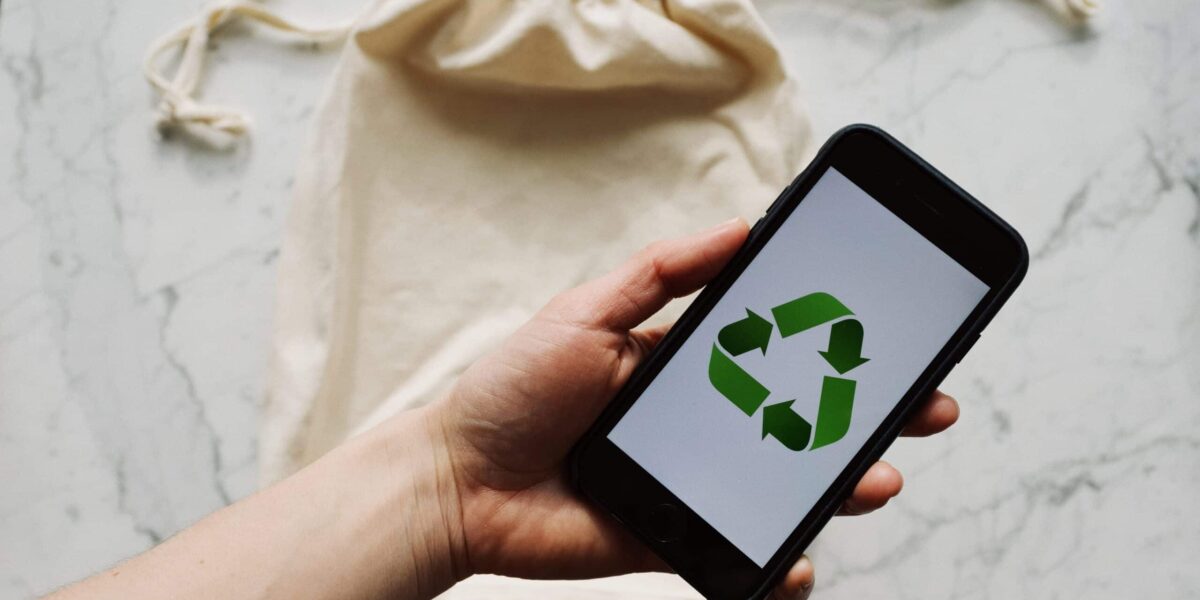 Free Faceless person showing recycle symbol on mobile phone screen Stock Photo