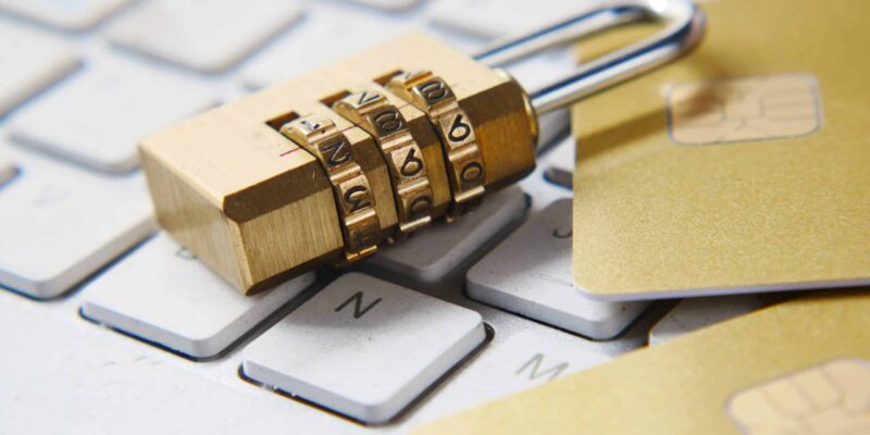 a golden padlock sitting on top of a keyboard