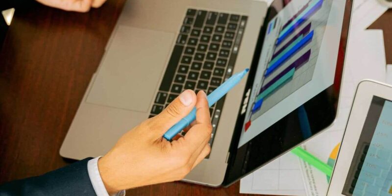 Free A Person in Black Suit Holding a Pen Stock Photo