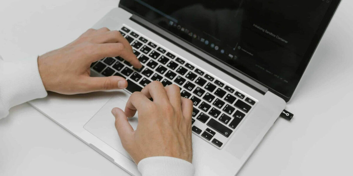 Free Hands on a Laptop Keyboard Stock Photo