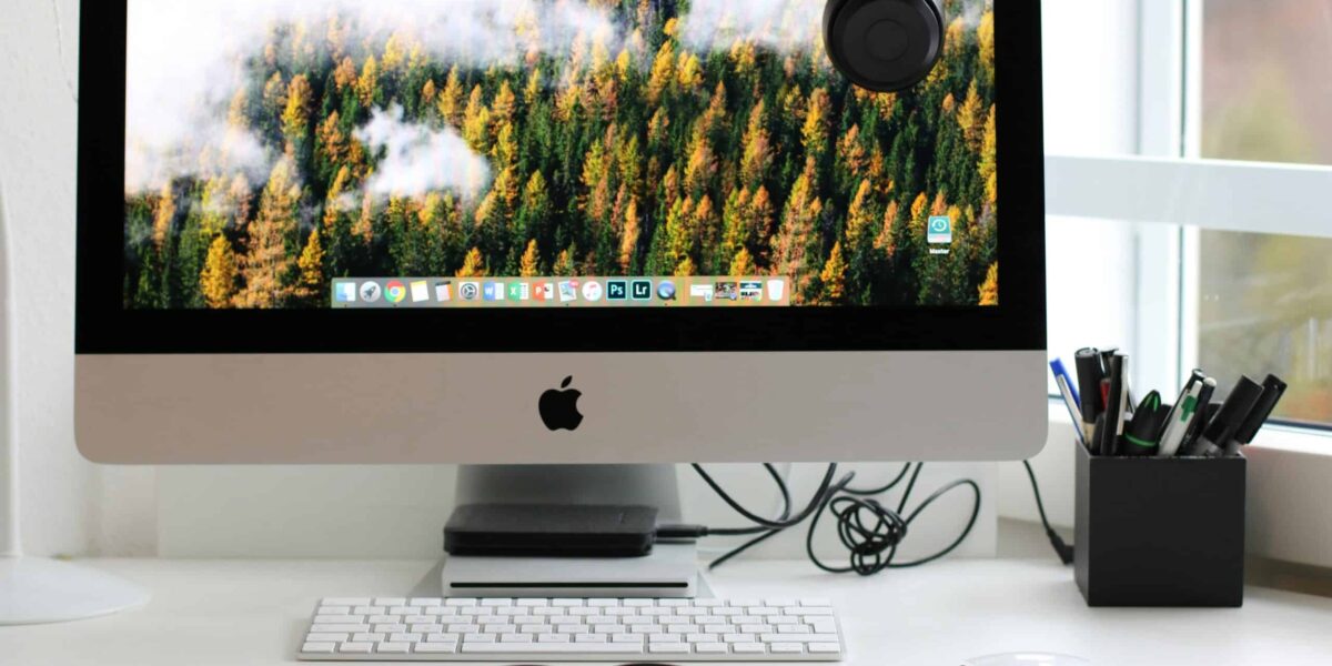 Free Stylish home office workspace featuring a computer setup with accessories. Stock Photo