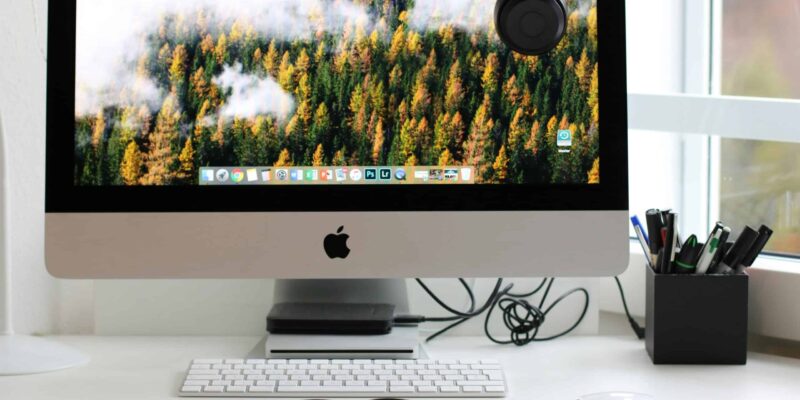Free Stylish home office workspace featuring a computer setup with accessories. Stock Photo