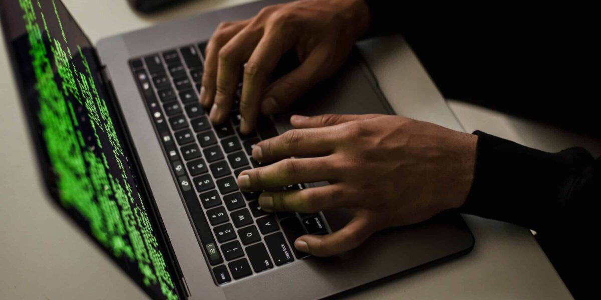crop-cyber-spy-hacking-system-while-typing-on-laptop