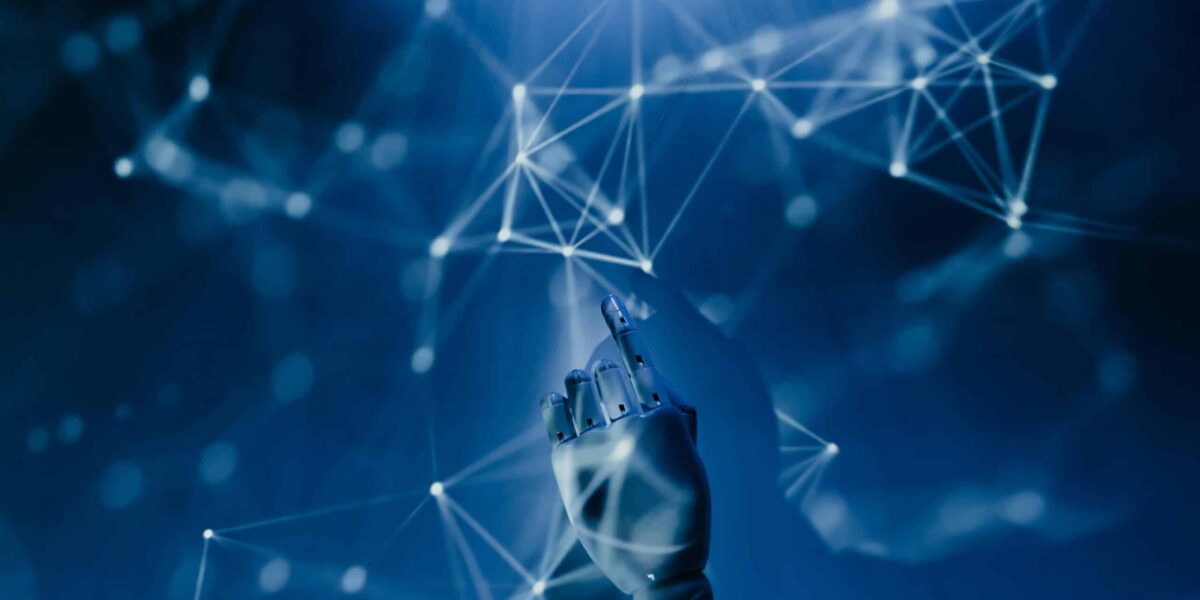 Free A robotic hand reaching into a digital network on a blue background, symbolizing AI technology. Stock Photo