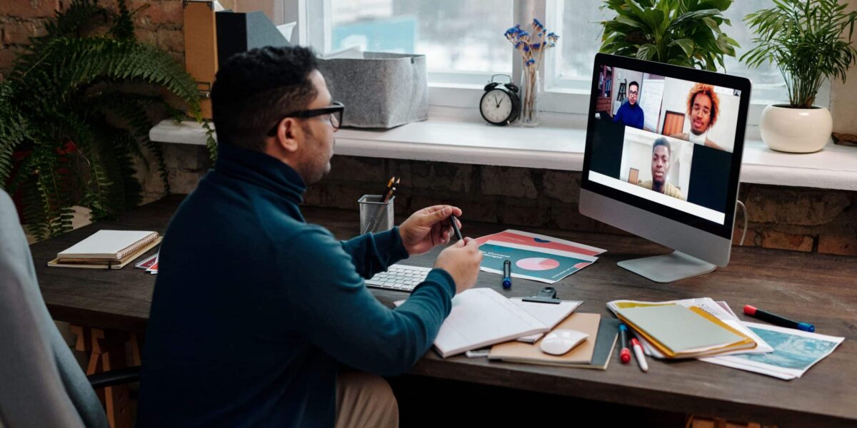 teacher-video-calling-with-his-students-using-a-computer